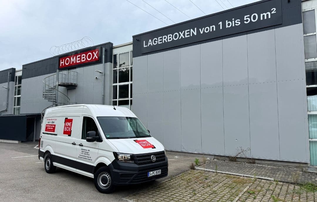 White HOMEBOX van parked in front of grey facade with red logo at HOMEBOX Stuttgart, Hafenbahnstr. 18A, Stuttgart